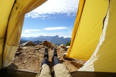 Low section of hiker lying in tent