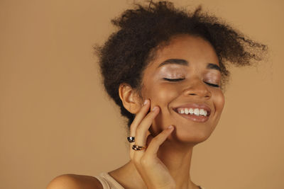 Smiling young woman against colored background