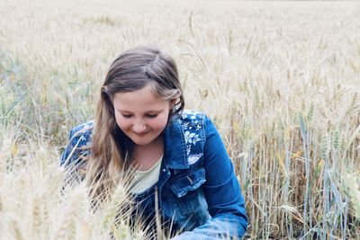 Close-up of girl looking away on field