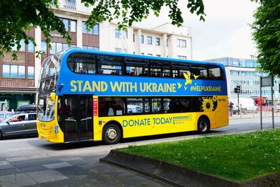 Close-up of bus on street in city