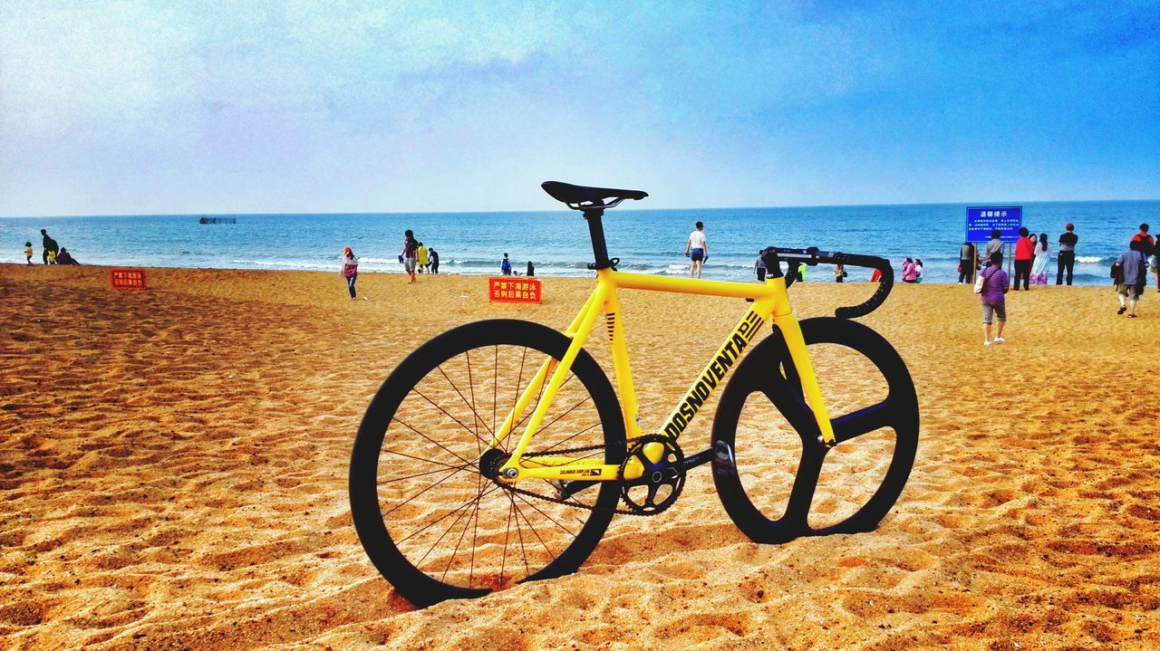 sea, beach, horizon over water, water, sand, shore, bicycle, large group of people, leisure activity, sky, vacations, lifestyles, scenics, men, mixed age range, beauty in nature, tranquil scene, transportation, blue