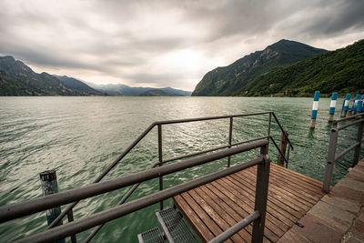 Scenic view of sea and mountains against sky