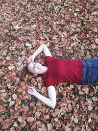 Low section of woman lying down on ground during autumn