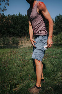 Midsection of man standing on field