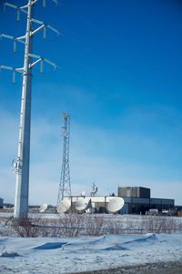 Electric pylons against sky