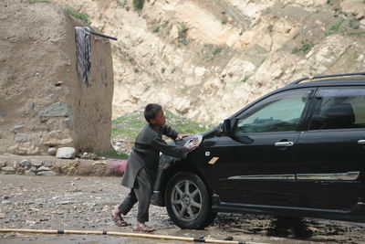 Afghan young child washing car