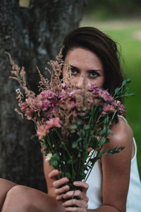 Midsection of woman holding flower bouquet