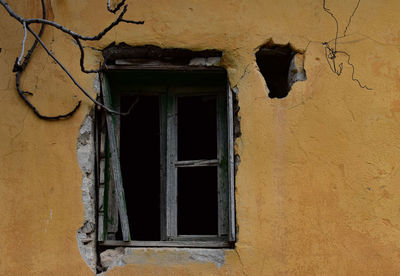 Low angle view of window on old building