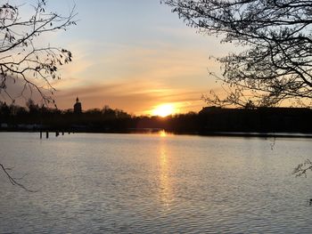 Scenic view of lake against orange sky