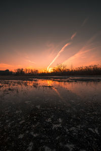 Scenic view of lake against sky during sunset