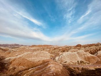 Scenic view of arid landscape against sky. karst landform with seven colors in zhangye.