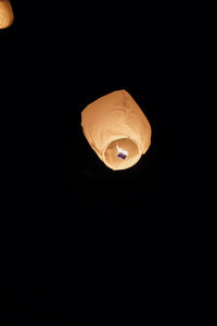 Illuminated lantern over black background