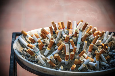 Close-up of cigarettes in ashtray on table