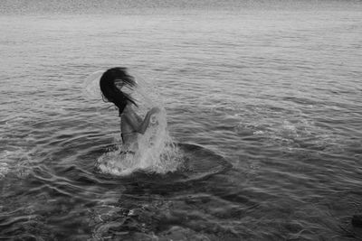 High angle view of woman swimming in sea