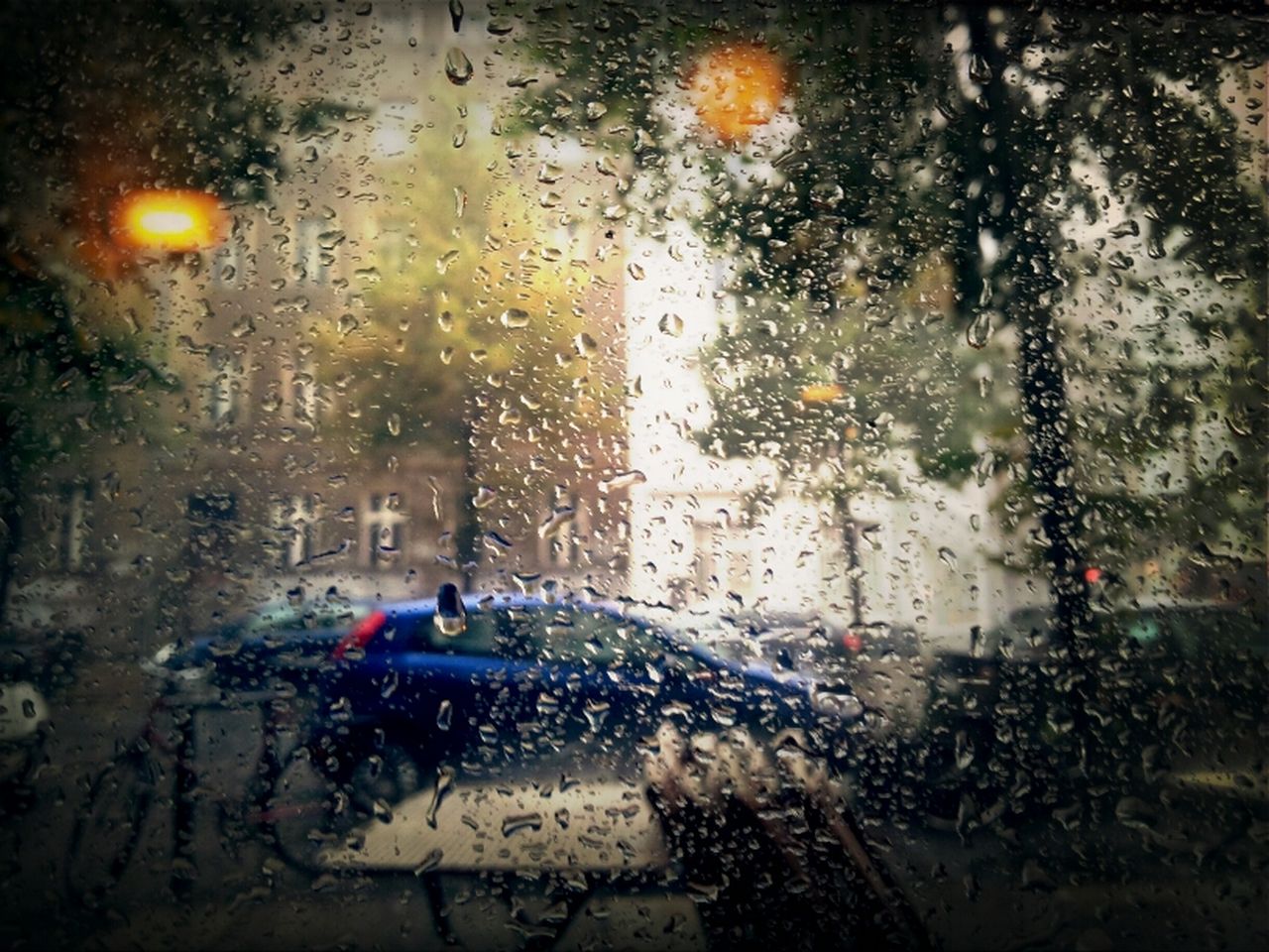 ROAD SEEN THROUGH WET WINDSHIELD