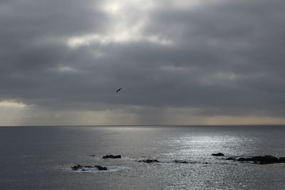 Scenic view of sea against cloudy sky