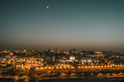 High angle view of illuminated buildings against sky at night