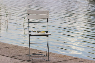 High angle view of empty chair on beach