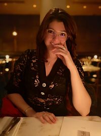 Portrait of a young woman drinking glass