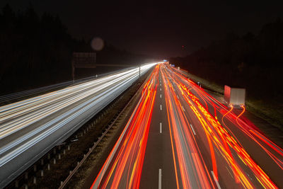 High angle view of light trails on highway at night