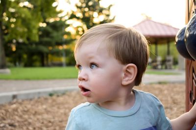 Portrait of cute boy looking away outdoors