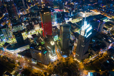 High angle view of city lit up at night