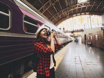 Full length of woman standing on train