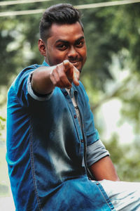 Portrait of smiling young man gesturing