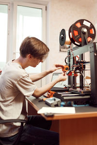 Side view of man working on table