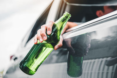 Man holding glass bottle