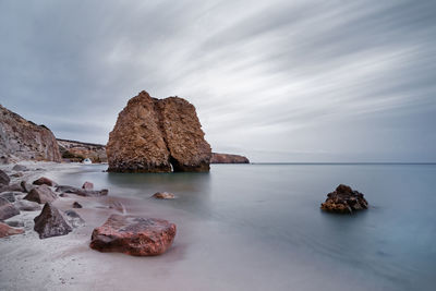 Rock formations in sea against sky