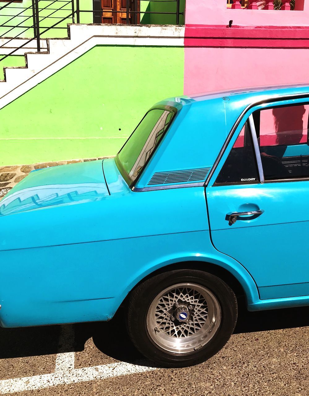 VINTAGE CAR PARKED AGAINST BLUE BACKGROUND