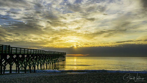 Scenic view of beach against sky during sunset