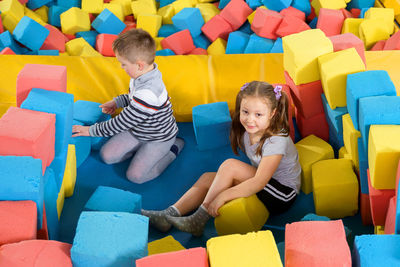 High angle view of people sitting with toys