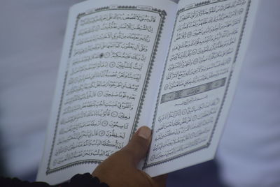 Midsection of woman reading book