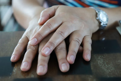 Close-up of woman hands on table