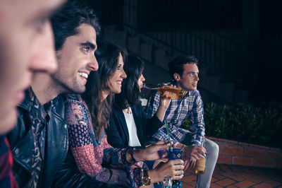 Happy young man drinking woman outdoors