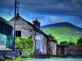 View of house against cloudy sky