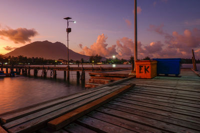 Pier over lake against sky