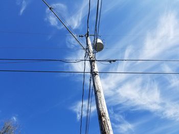 Low angle view of electricity pylon against sky