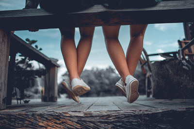 Low section of woman walking on footpath