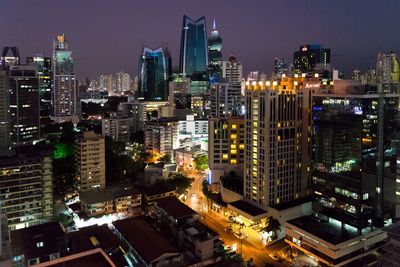 Illuminated modern buildings in city at night