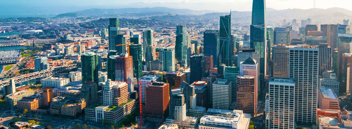 Aerial view of modern buildings in city against sky