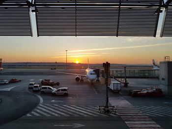 View of airport runway against sky during sunset