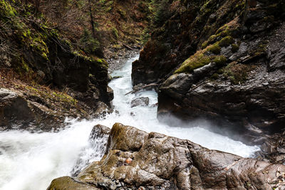 Scenic view of river flowing through rocks