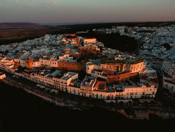 High angle shot of townscape against sky at sunset