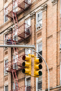 Low angle view of stoplight against building