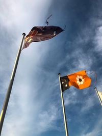 Low angle view of flag on pole against sky