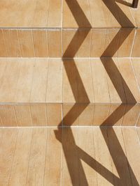 High angle view of shadow on tiled floor