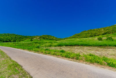 Empty road along countryside landscape